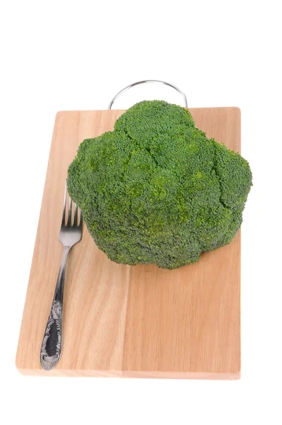 Broccoli with fork on cutting board isolated on white — Stock Photo, Image