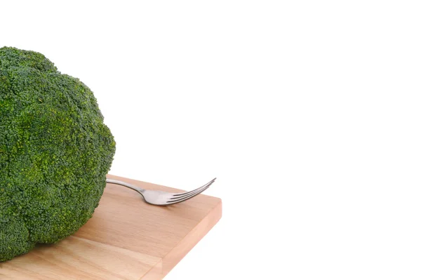 Broccoli with fork on cutting board isolated on white — Stock Photo, Image