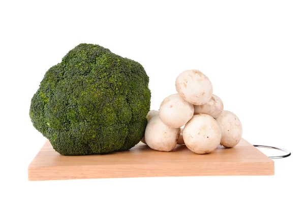 Mushrooms brocolli on the cutting board isolated on the white background — Stock Photo, Image