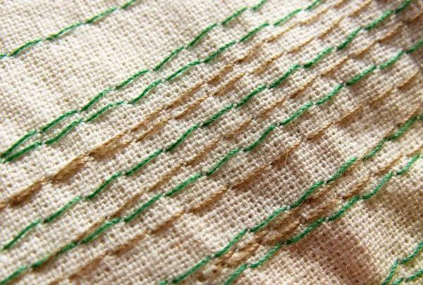 Embroidery stitches on the fabric. Background. Macro. Manual work. — Stock Photo, Image