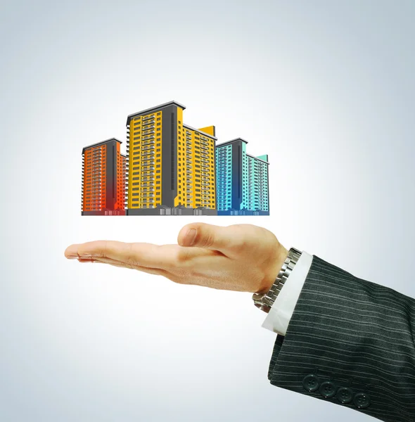 Buildings in businessman's hand — Stock Photo, Image