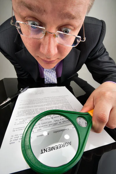 Bizarre businessman examining the agreement — Stock Photo, Image