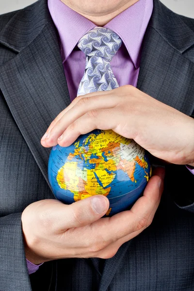 Businessman carrying world globe — Stock Photo, Image