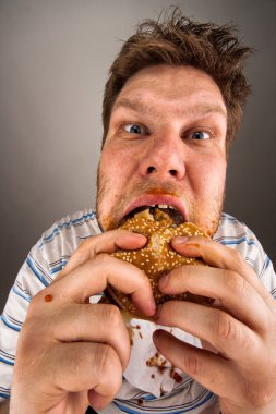 Man chewing hamburger clipart