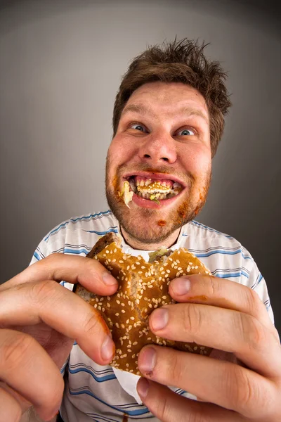 Uomo masticare hamburger — Foto Stock