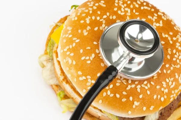 Fast food com estetoscópio médico — Fotografia de Stock