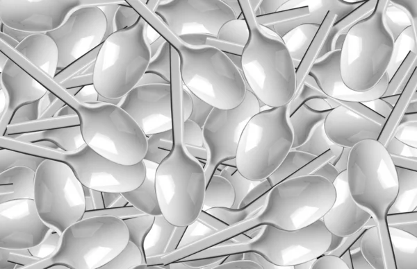 Many white plastic spoons — Stock Photo, Image
