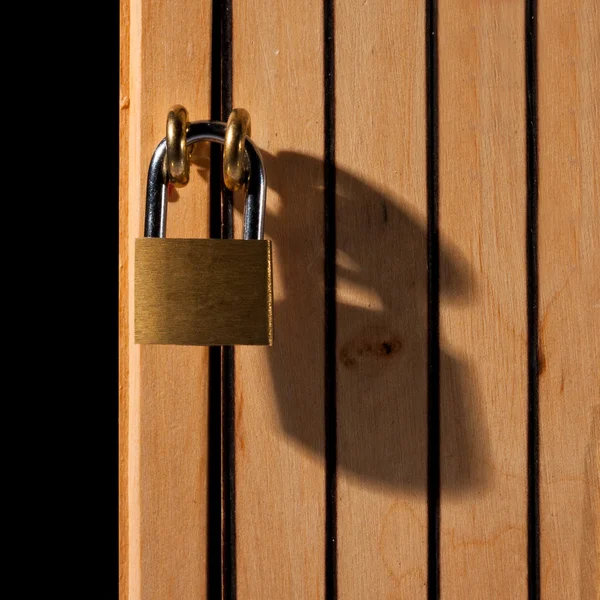Padlock on wooden door — Stock Photo, Image