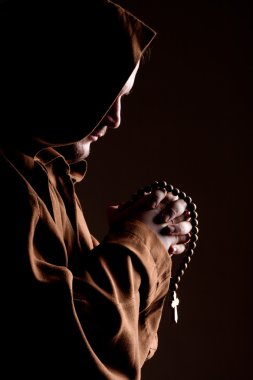 Monk with two hands clasped in prayer clipart