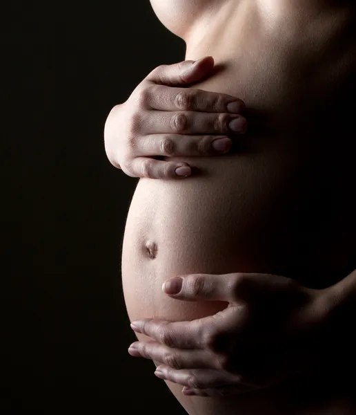 Mujer embarazada sosteniendo el abdomen —  Fotos de Stock