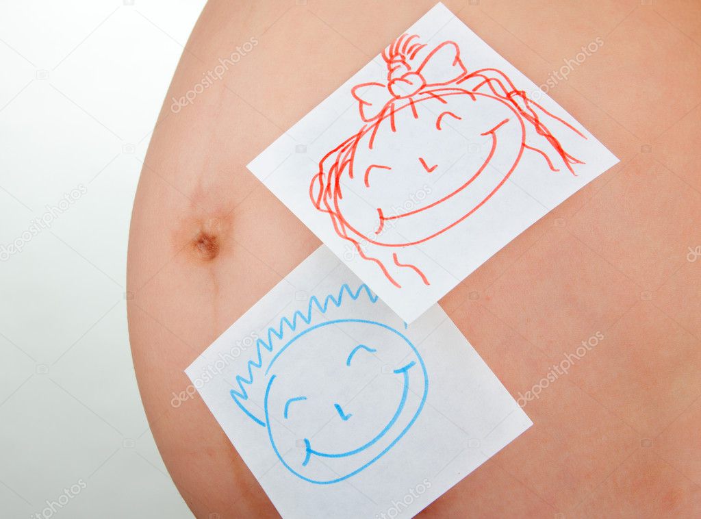 Paper stickers on pregnant woman abdomen