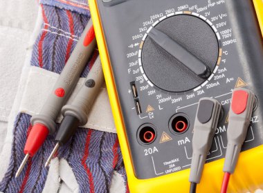 Digital multimeter, probes and gloves clipart