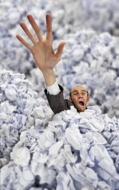 Businessman sinking in big heap of crumpled papers clipart