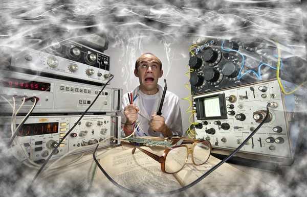 Funny nerd scientist soldering at vintage laboratory — Stock Photo, Image