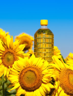 Bottle of oil with sunflowers clipart