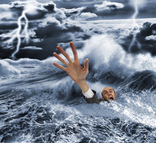 Businessman sinking in dark stormy sea