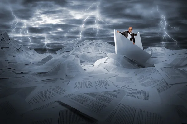 Businessman sailing in stormy papers sea — Stock Photo, Image