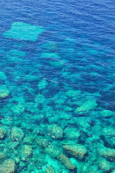 Rocks in turquoise sea — Stock Photo, Image