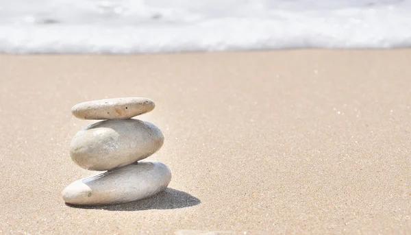 Stacked pebbles in the sand — Stock Photo, Image