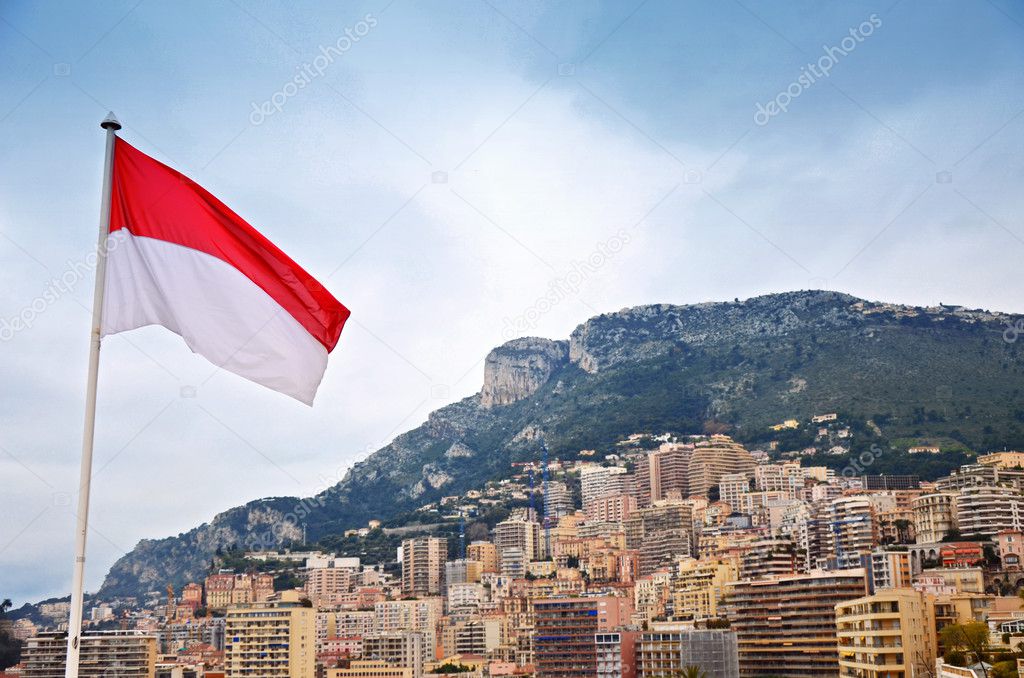 The flag of Monaco and city in the background