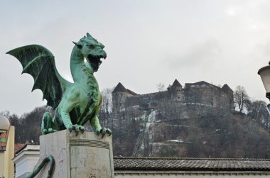 Ljubljana castle in the background of the Dragon bridge clipart