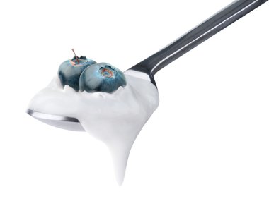 Spoon of yogurt with blueberries on top clipart