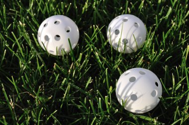 Three White Plastic Wiffle Golf Balls clipart