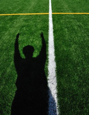 Shadow of American Football Referee Signaling Touchdown clipart