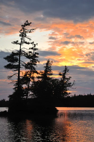 Île panoramique sur un lac sauvage éloigné au coucher du soleil — Photo