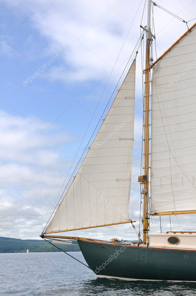Jib, Foresail, and Wooden Mast of Schooner Sailboat