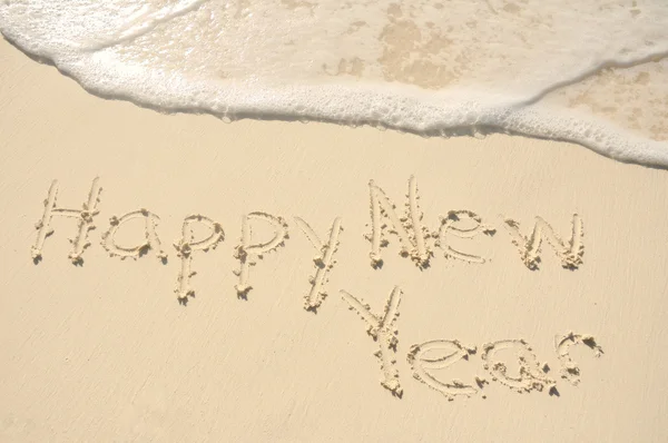 Šťastný nový rok v písku na pláži — Stock fotografie