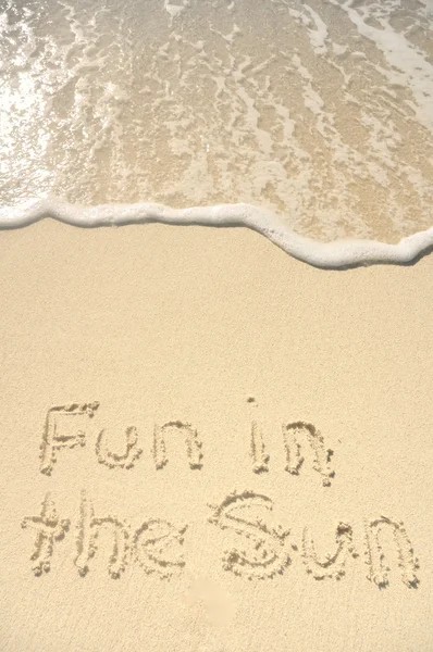 Pret in de zon geschreven in het zand op het strand — Stockfoto
