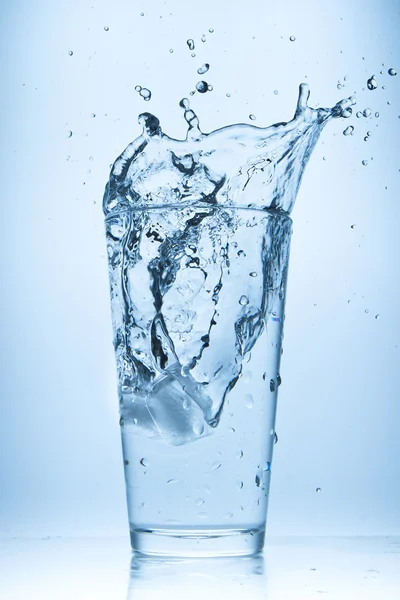 Water splash in glass Stock Image