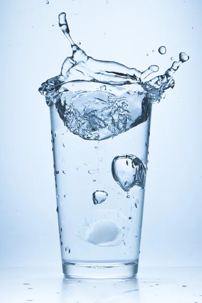 Water splash in glass Stock Photo