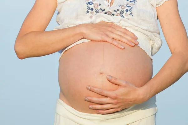 Gravid kvinne på strand – stockfoto