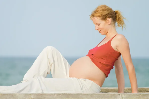 Zwangere vrouw op strand — Stockfoto