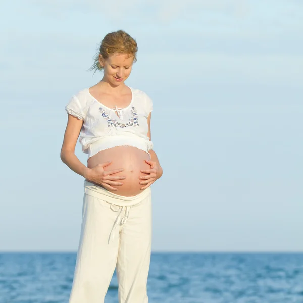 Kobieta w ciąży na plaży — Zdjęcie stockowe