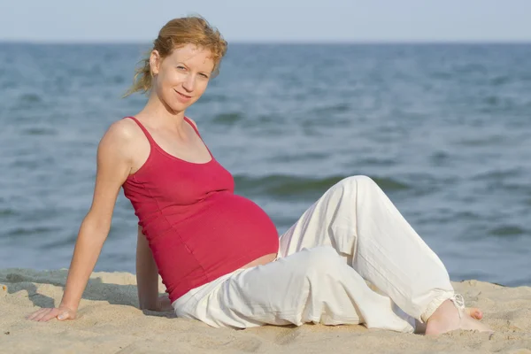 Pregnant woman on beach Stock Image