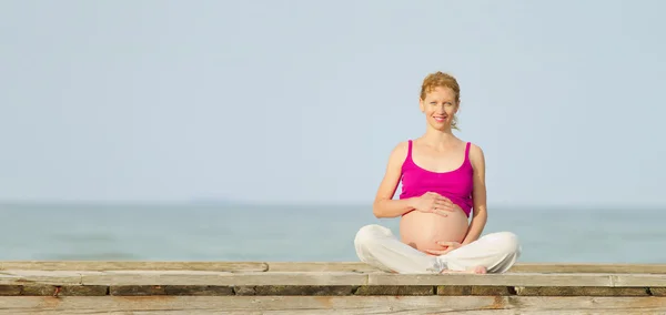 Pregnant woman on beach Stock Picture