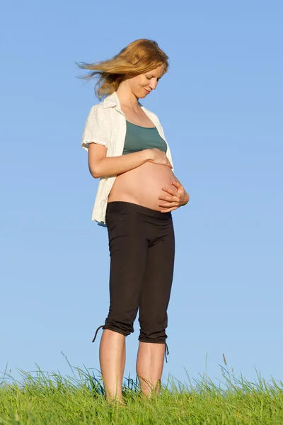 Donna incinta sul prato — Foto Stock