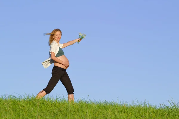 Těhotná žena na louce — Stock fotografie