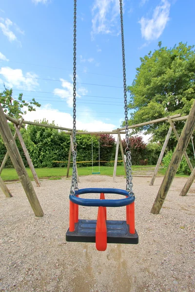 Blue and red swing — Stock Photo, Image