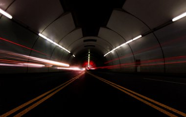 Vehicles Passing Fast in a Tunnel Leaving Light Streaks clipart