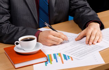 Businessman's table covered with documents clipart