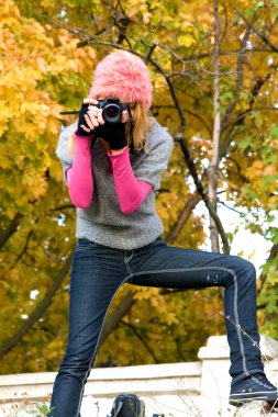 Cute girl taking a photograph clipart