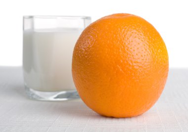 Fresh orange with milk on background clipart