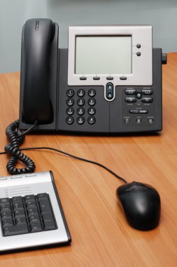 Digital phone on office table clipart