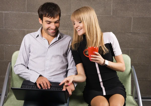 若い男性と女性のノート パソコンで座っています。 — ストック写真
