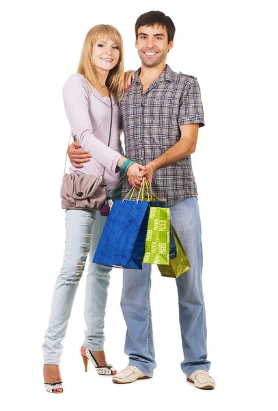 Vackra unga par med kassar och påsar — Stockfoto