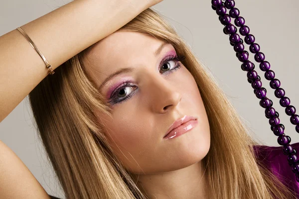 Beautiful young woman with beads — Stock Photo, Image